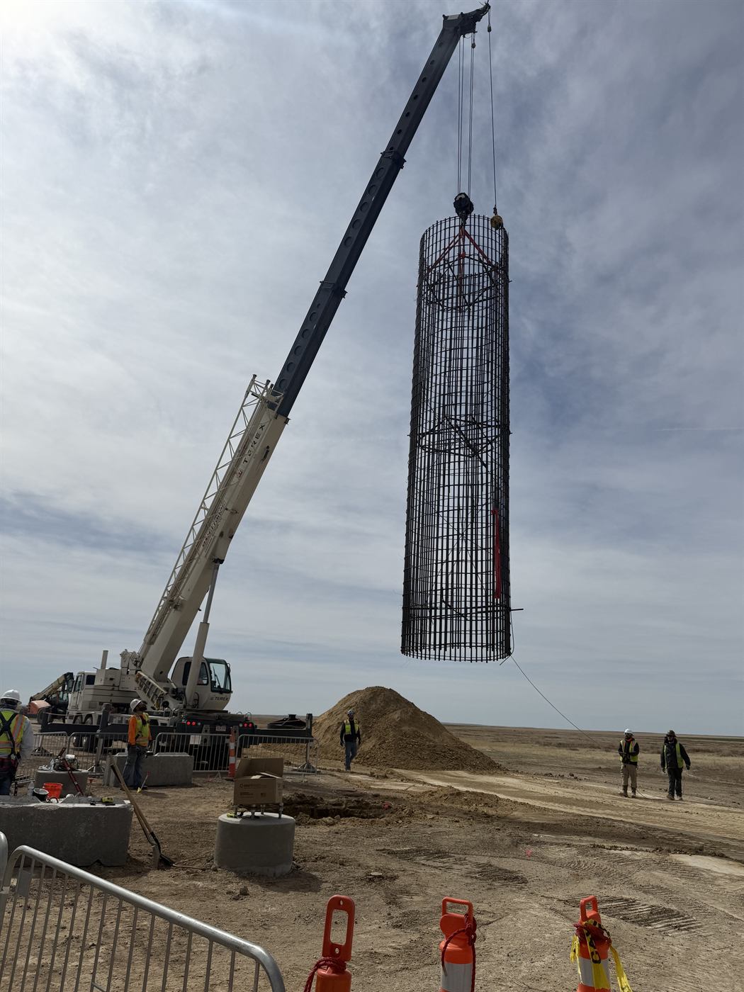 Crew in full PPE setting an anchor-bolt template